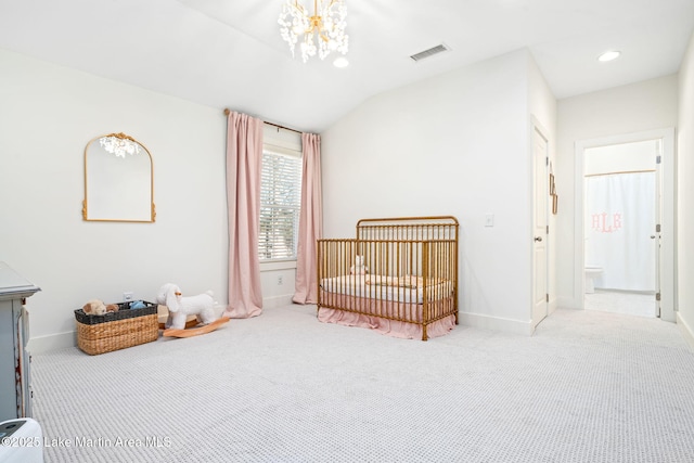 carpeted bedroom featuring a chandelier, ensuite bathroom, a nursery area, and vaulted ceiling