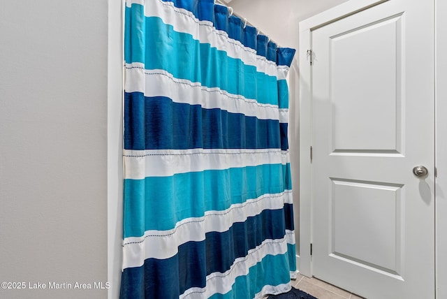 bathroom featuring tile patterned floors and curtained shower