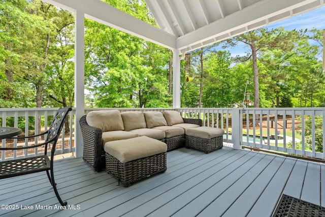 wooden terrace with an outdoor hangout area