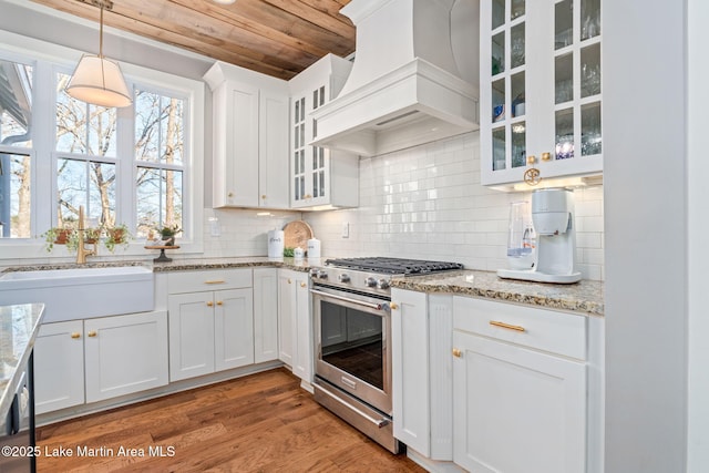 kitchen featuring custom exhaust hood, wooden ceiling, white cabinets, sink, and stainless steel range