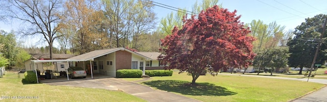 240 Windsor Dr, Alexander City, AL 35010 - view of front of house featuring driveway, a front yard, and an attached carport