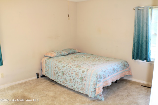 240 Windsor Dr, Alexander City, AL 35010 - carpeted bedroom featuring multiple windows and baseboards