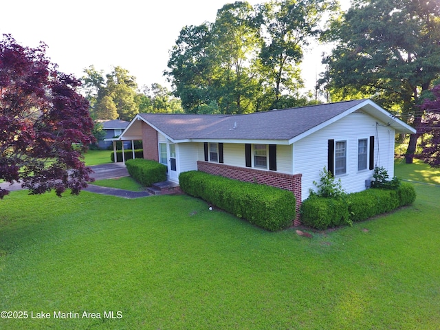 240 Windsor Dr, Alexander City, AL 35010 - ranch-style home featuring a front yard, a shingled roof, a carport, and brick siding