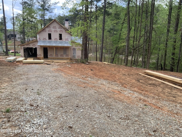 property in mid-construction with a chimney