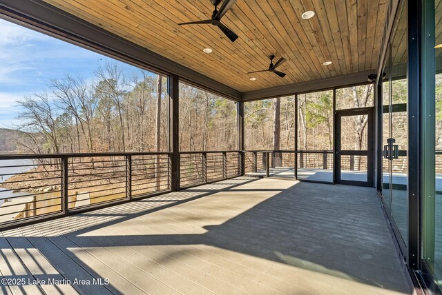 unfurnished sunroom featuring ceiling fan