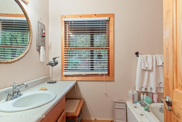 bathroom with vanity and a bath