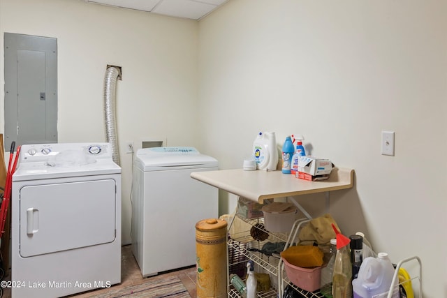 clothes washing area featuring electric panel and washing machine and clothes dryer