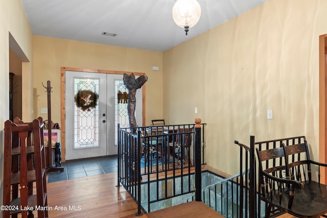 entrance foyer with dark hardwood / wood-style flooring and french doors