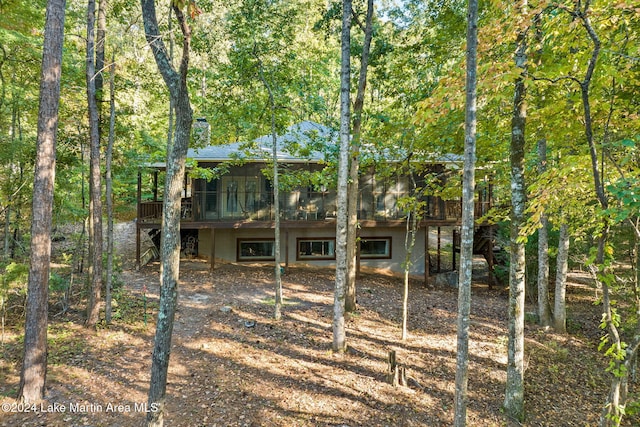 back of house featuring a deck and a sunroom