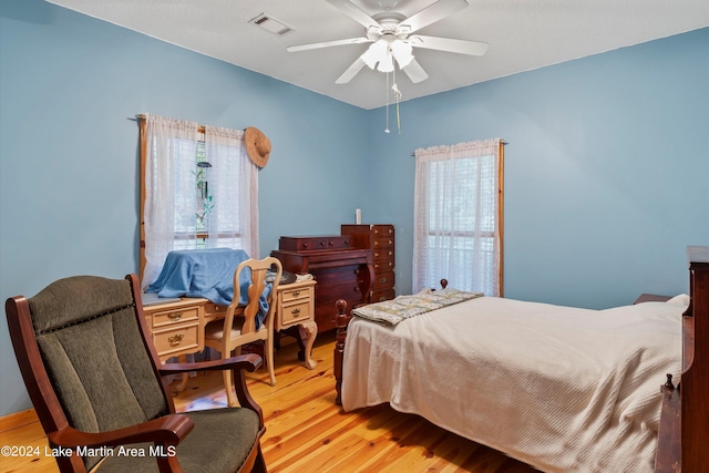 bedroom with light hardwood / wood-style flooring and ceiling fan