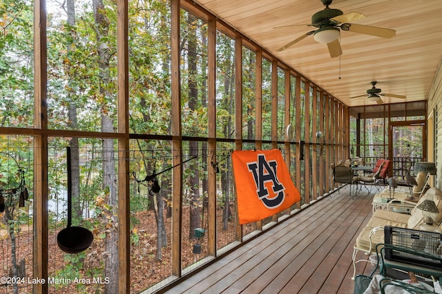 unfurnished sunroom with ceiling fan and wood ceiling