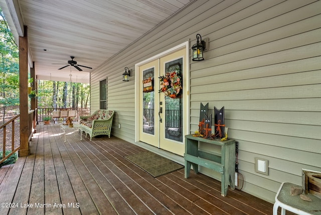 wooden terrace featuring covered porch and ceiling fan