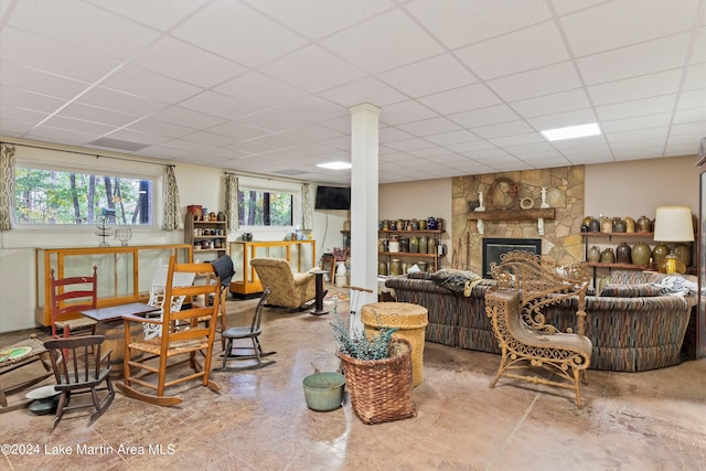 living room with a fireplace and a paneled ceiling