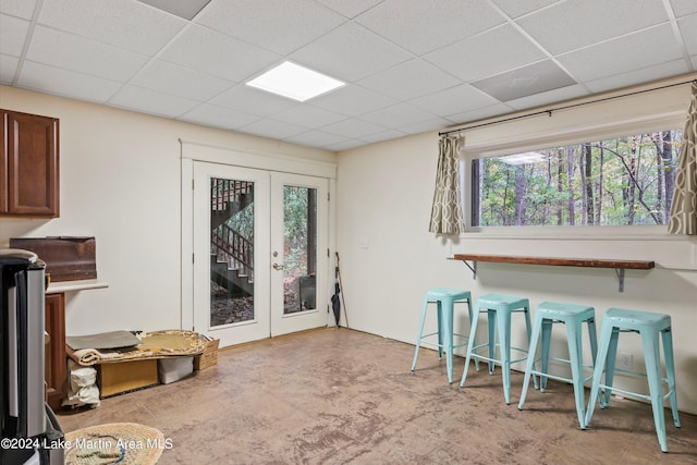 dining space featuring a paneled ceiling and french doors