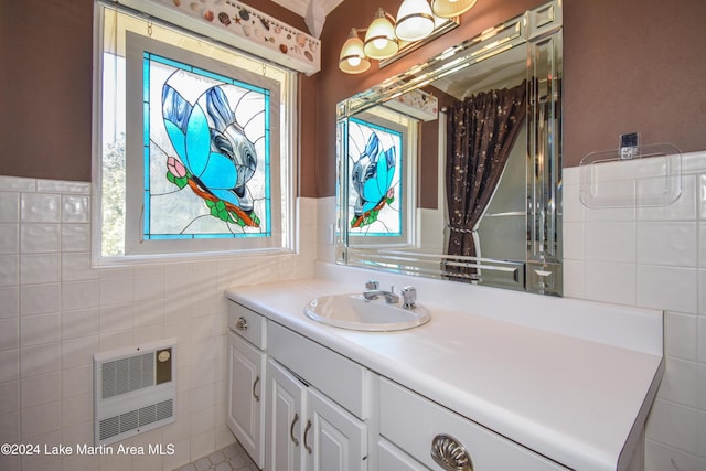 bathroom featuring vanity, heating unit, and tile walls