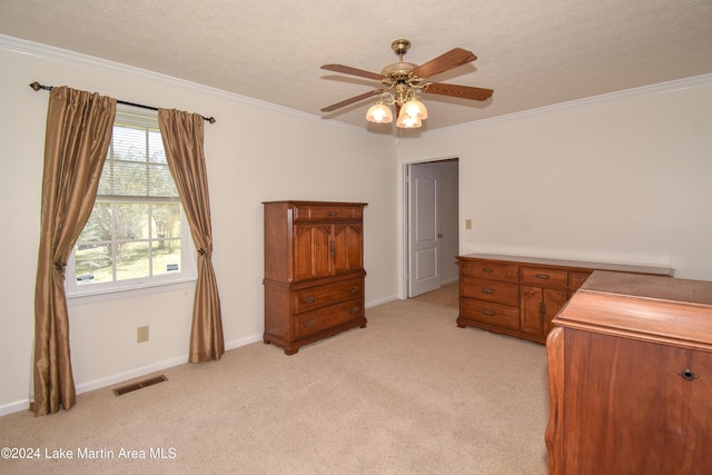 carpeted bedroom with a textured ceiling, ceiling fan, and ornamental molding