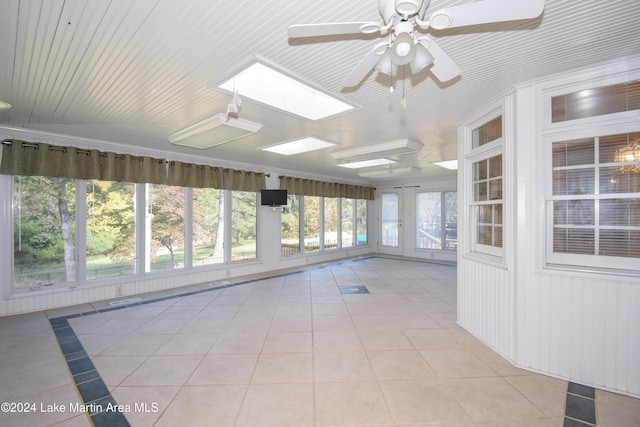 unfurnished sunroom featuring a skylight and ceiling fan