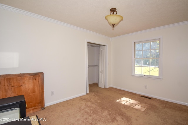 unfurnished bedroom with light carpet, a closet, and ornamental molding