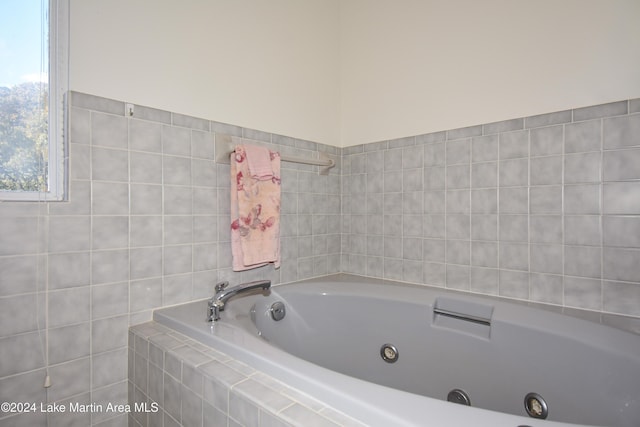 bathroom with a relaxing tiled tub