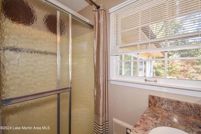 bathroom with vanity and walk in shower