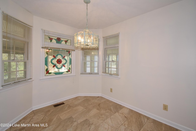 unfurnished dining area featuring an inviting chandelier