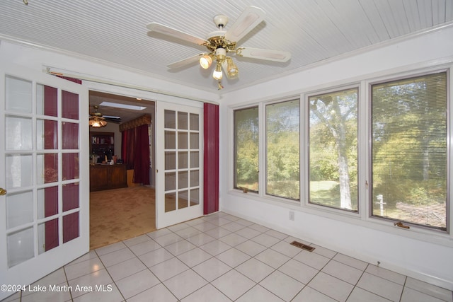 unfurnished sunroom with french doors