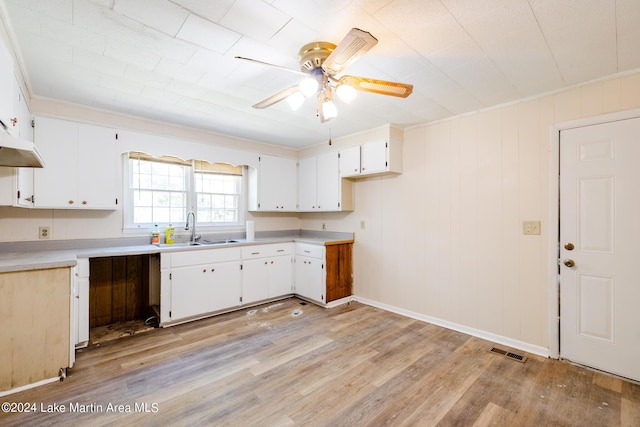 kitchen featuring white cabinets, ceiling fan, light hardwood / wood-style flooring, and sink