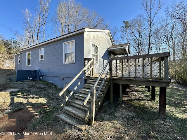 exterior space featuring a wooden deck and cooling unit