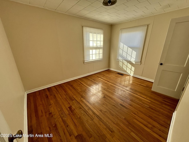 spare room with hardwood / wood-style floors