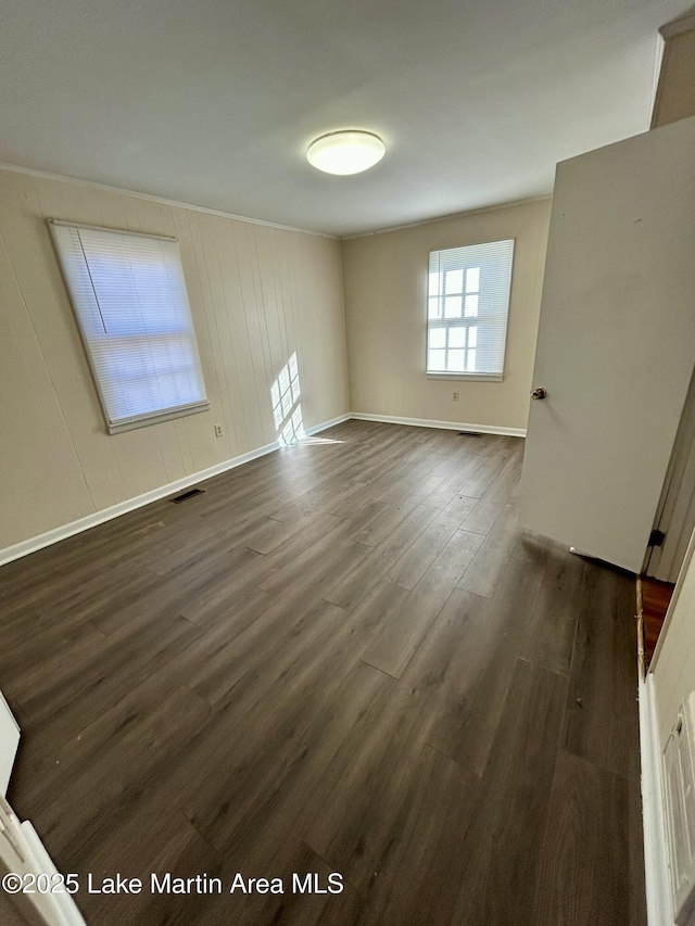 unfurnished room featuring dark wood-type flooring