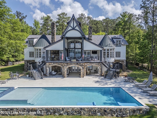1071 Trillium W Pkwy, Eclectic, AL 36024 - back of property with stairs, a chimney, a patio, and stone siding