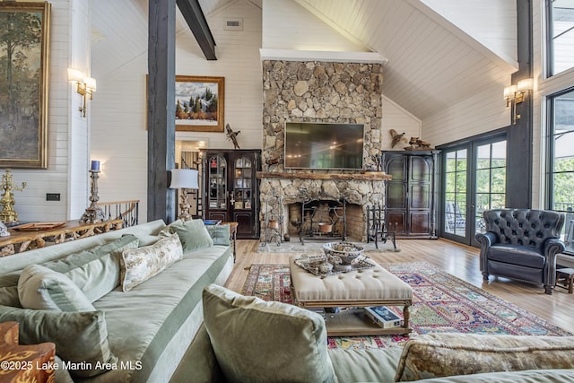 1071 Trillium W Pkwy, Eclectic, AL 36024 - living area with a fireplace, wood walls, beam ceiling, high vaulted ceiling, and hardwood / wood-style floors