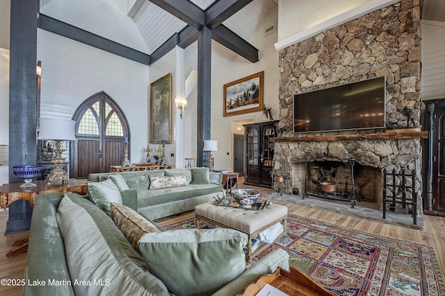1071 Trillium W Pkwy, Eclectic, AL 36024 - living area with a stone fireplace, wood finished floors, high vaulted ceiling, and beamed ceiling