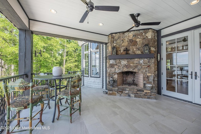1071 Trillium W Pkwy, Eclectic, AL 36024 - sunroom / solarium with ceiling fan and a stone fireplace