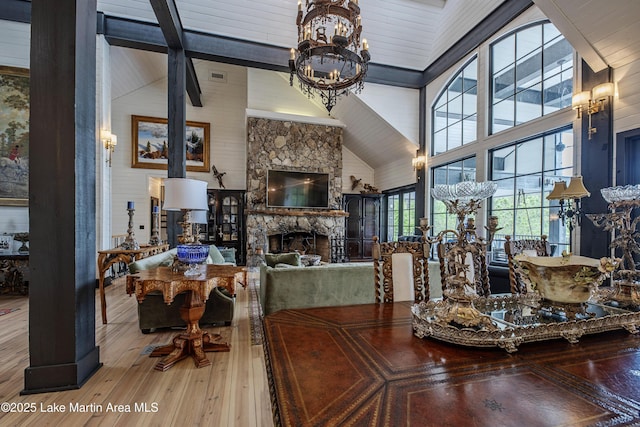 1071 Trillium W Pkwy, Eclectic, AL 36024 - dining space featuring a fireplace, hardwood / wood-style flooring, beam ceiling, high vaulted ceiling, and an inviting chandelier