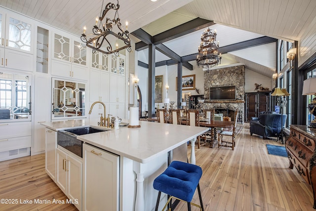 1071 Trillium W Pkwy, Eclectic, AL 36024 - kitchen with a sink, light wood-style flooring, a kitchen island with sink, and a chandelier
