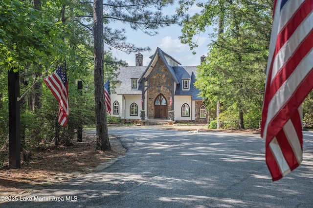 1071 Trillium W Pkwy, Eclectic, AL 36024 - tudor home featuring a chimney, a high end roof, and stone siding