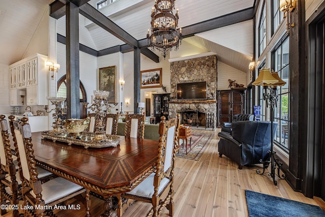1071 Trillium W Pkwy, Eclectic, AL 36024 - dining room with an inviting chandelier, beam ceiling, a fireplace, light wood-style floors, and high vaulted ceiling