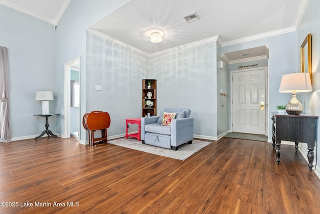 living area featuring visible vents, baseboards, and wood finished floors