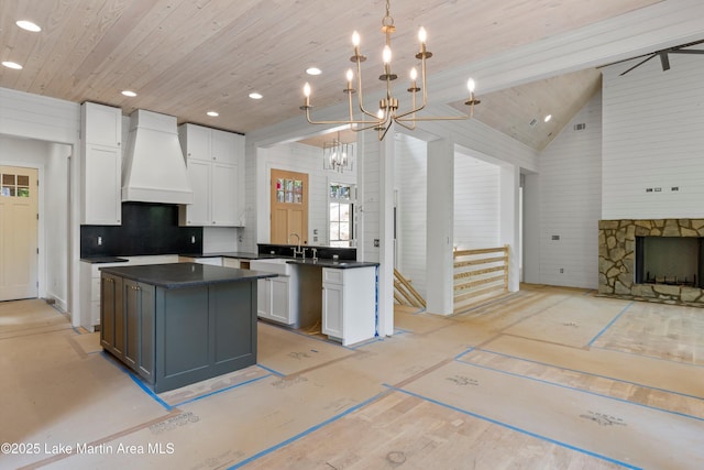 74 Cedar Rdg, Alexander City, AL 35010 - kitchen with custom range hood, wood ceiling, dark countertops, white cabinetry, and open floor plan