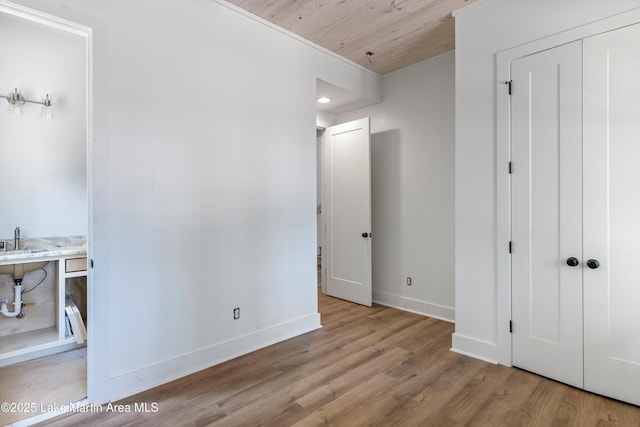 74 Cedar Rdg, Alexander City, AL 35010 - unfurnished bedroom featuring wood finished floors, wood ceiling, baseboards, a closet, and a sink