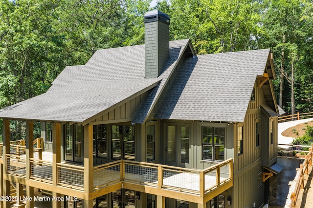 74 Cedar Rdg, Alexander City, AL 35010 - back of property featuring a shingled roof, board and batten siding, a chimney, a wooden deck, and french doors