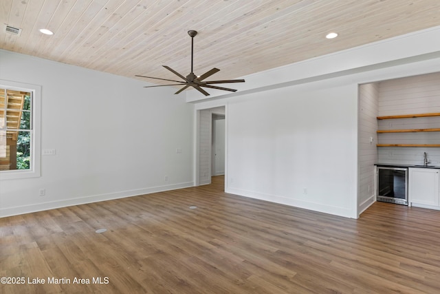 74 Cedar Rdg, Alexander City, AL 35010 - unfurnished living room with wine cooler, recessed lighting, ceiling fan, wood ceiling, and light wood-type flooring