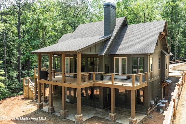 74 Cedar Rdg, Alexander City, AL 35010 - rear view of house with roof with shingles, board and batten siding, a chimney, a wooden deck, and stairs