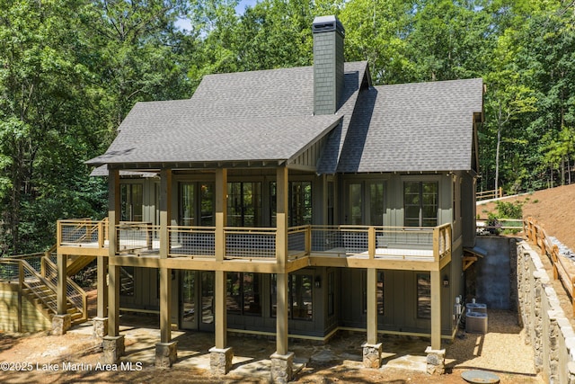 74 Cedar Rdg, Alexander City, AL 35010 - rear view of property with roof with shingles, board and batten siding, a wooden deck, a chimney, and stairway