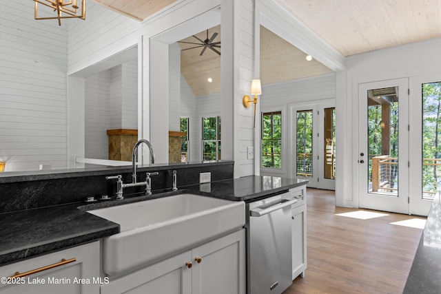 74 Cedar Rdg, Alexander City, AL 35010 - kitchen with stainless steel dishwasher, wooden ceiling, plenty of natural light, wooden walls, and light wood-style flooring
