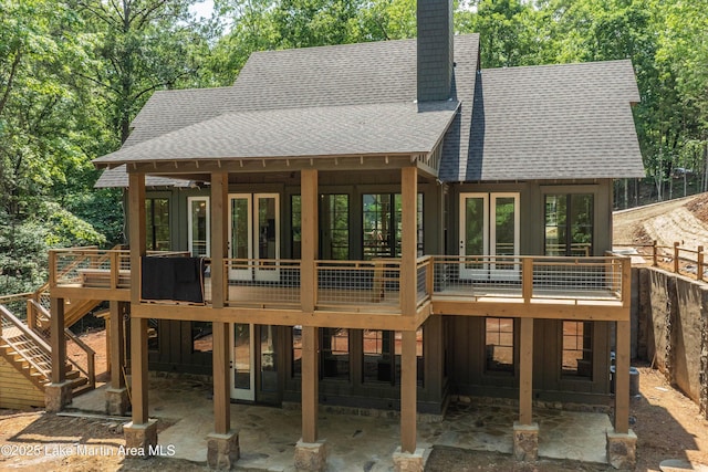 74 Cedar Rdg, Alexander City, AL 35010 - back of house with a shingled roof, a chimney, a wooden deck, and a patio