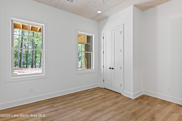 74 Cedar Rdg, Alexander City, AL 35010 - unfurnished bedroom featuring multiple windows, light wood finished floors, crown molding, wood ceiling, and a closet