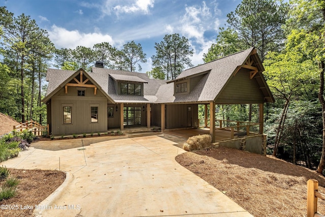 74 Cedar Rdg, Alexander City, AL 35010 - chalet / cabin with a shingled roof, a porch, concrete driveway, and a chimney