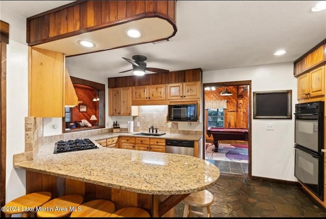 kitchen with kitchen peninsula, ceiling fan, sink, black appliances, and billiards